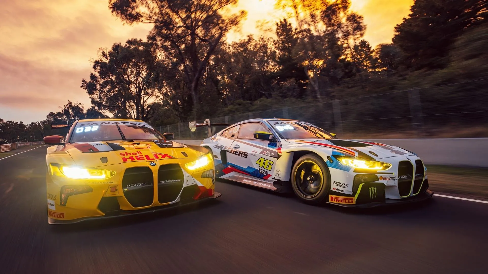 Colorful Bmw Race Cars Speeding on a Racing Track Wallpaper