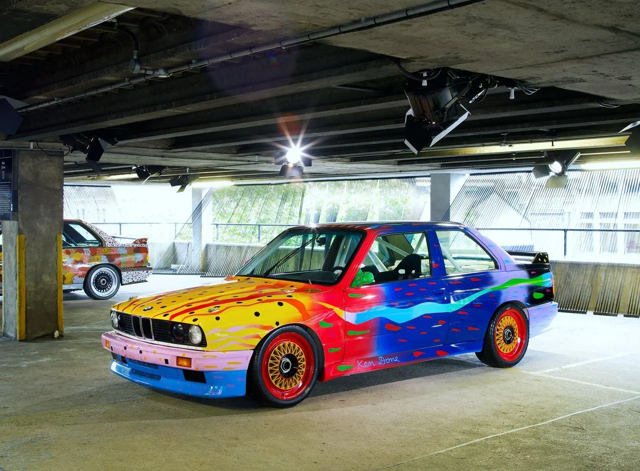 Colorful Bmw Racing Car Displayed in Garage Setting