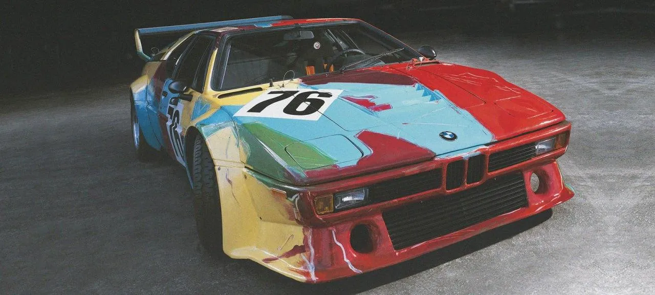 Colorful Vintage Bmw Race Car on a Race Track Wallpaper