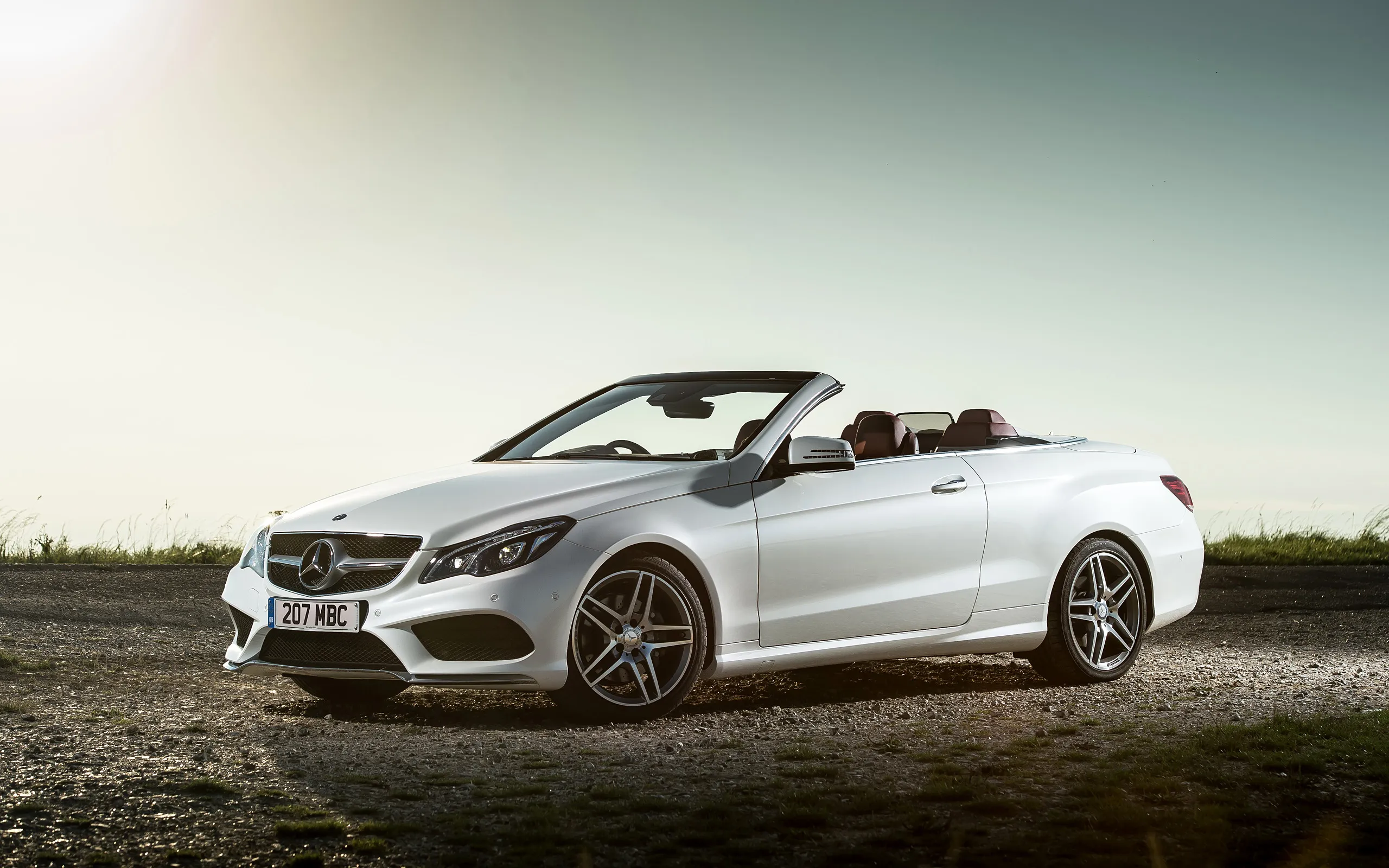Convertible Mercedes in a Scenic Sunset Drive Wallpaper