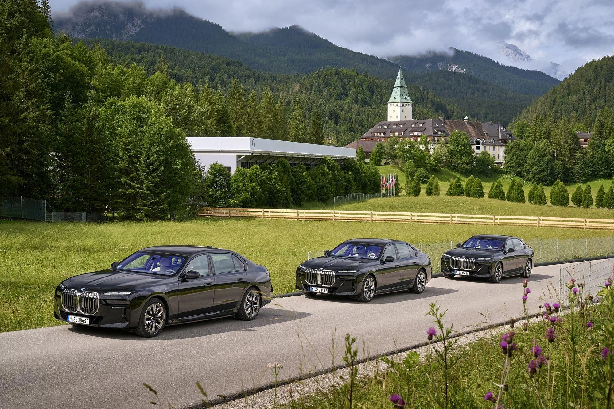 Convoy of Bmw Sedans Driving on Scenic Mountain Road