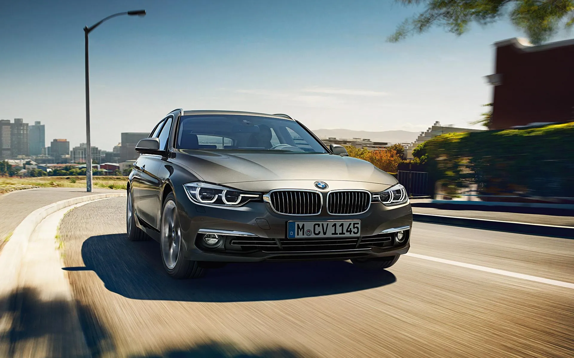 Dark Bmw Sedan Driving Fast Through Urban Expressway