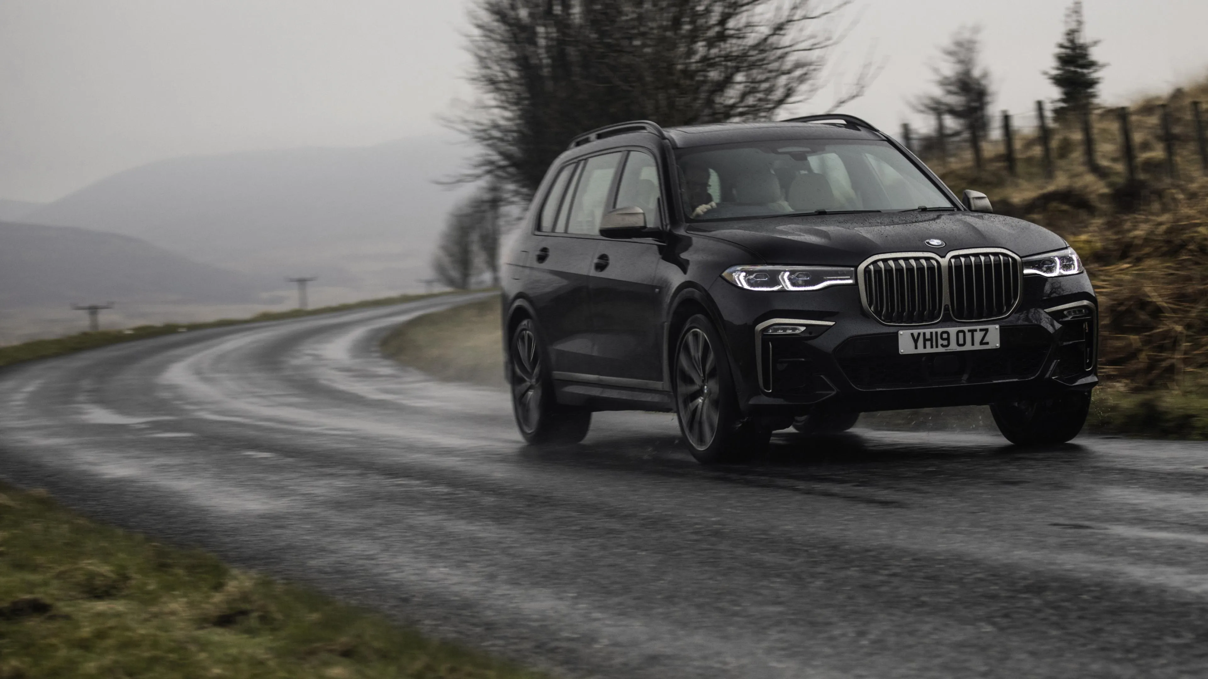Dark Bmw Suv Turning on a Forest Mountain Road Image
