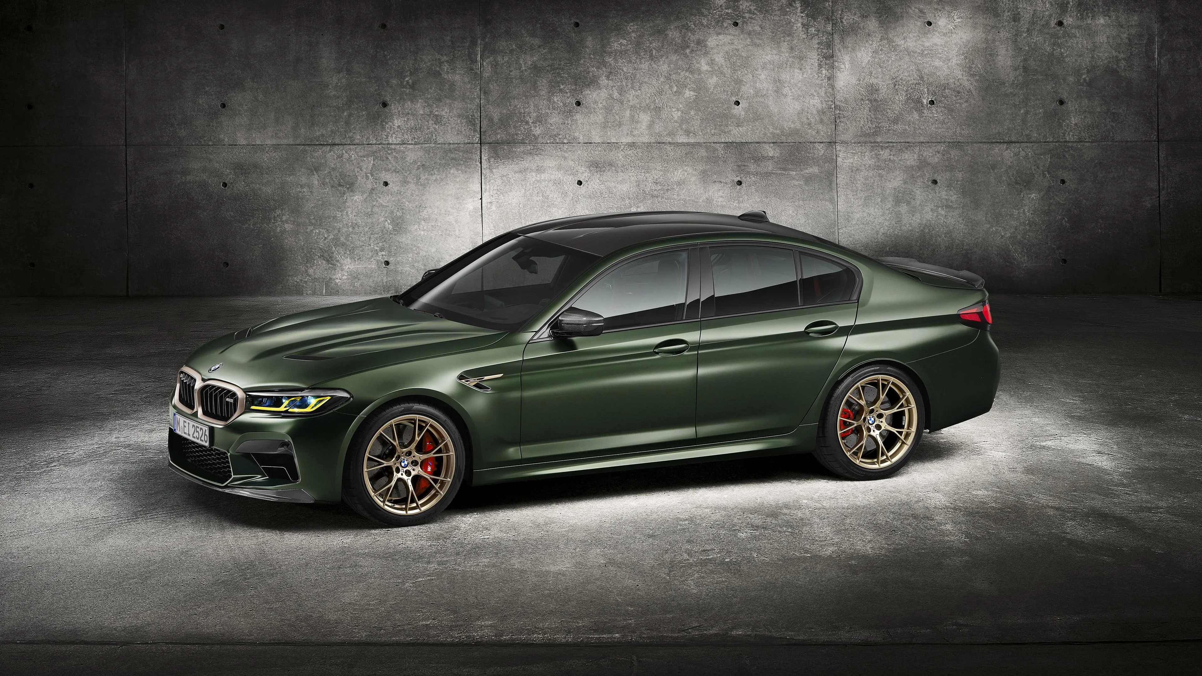 Dark Green Bmw Parked Indoors with Spotlight Lighting