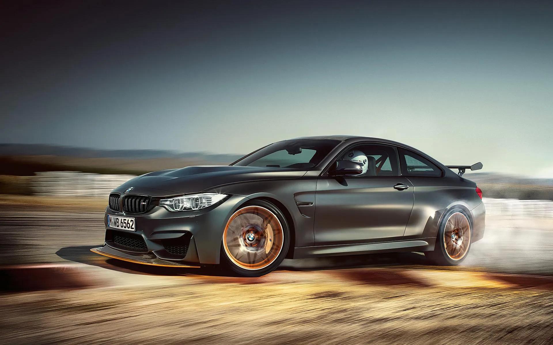 Dark Grey Bmw Sedan Drifting on a Desert Road Image