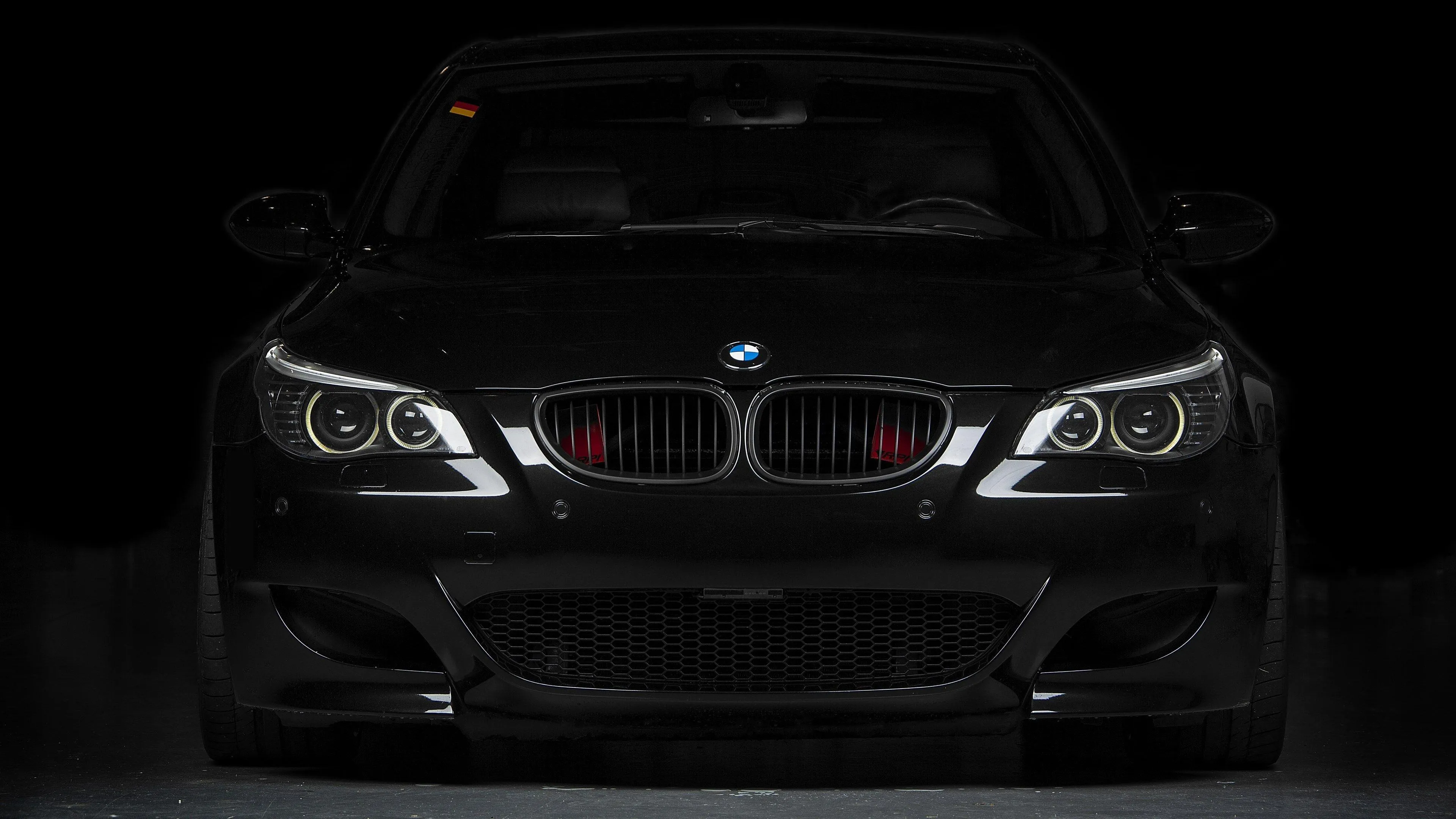 Dark Themed Bmw Front View with Aggressive Look Wallpaper