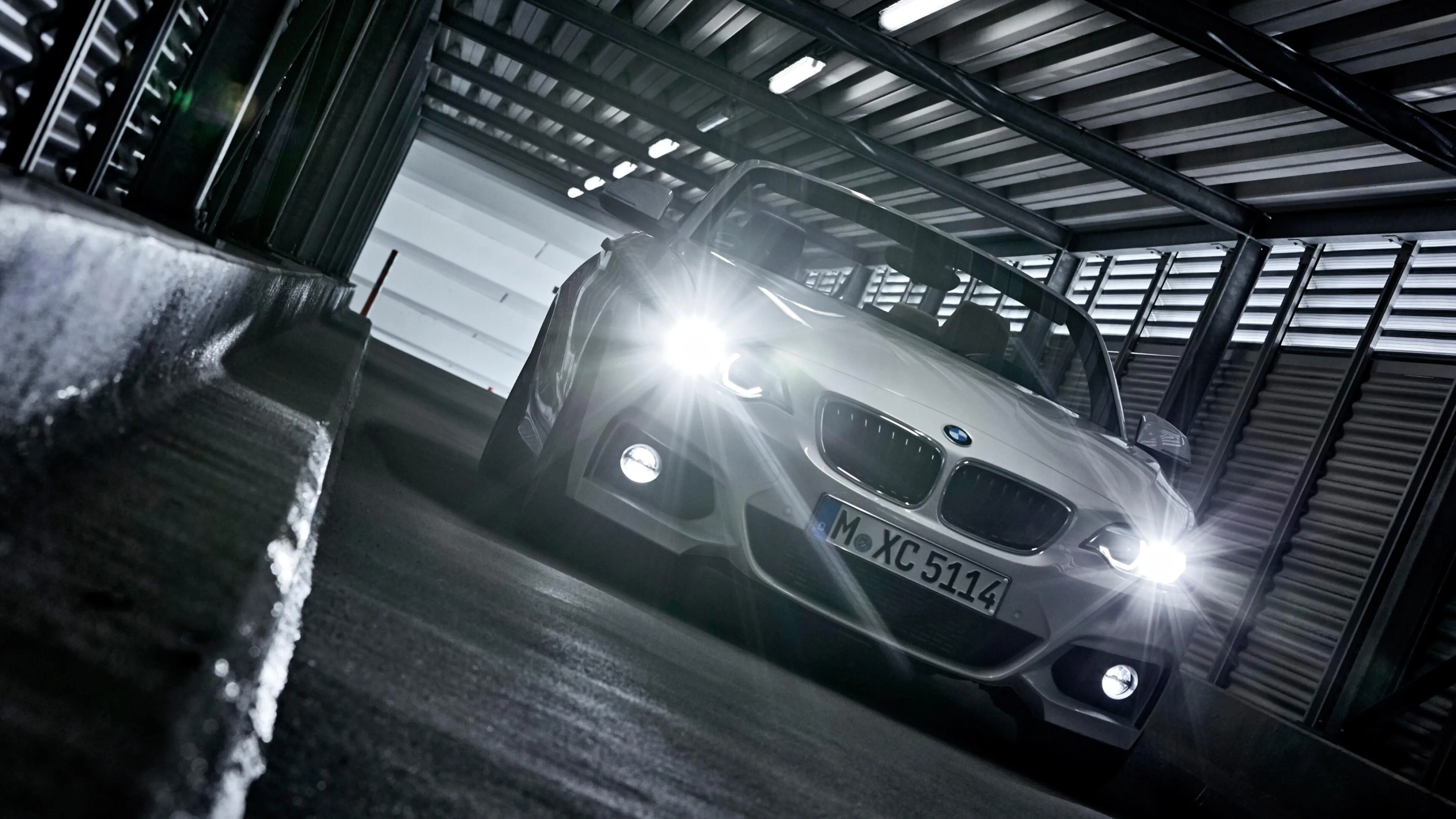 Dramatic Closeup of Bmw with Headlights on in Dark Space