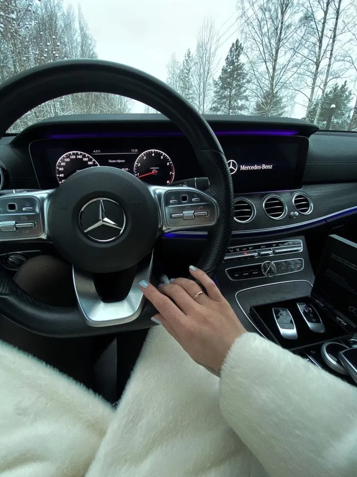 Driver Inside Mercedes Benz Holding Steering Wheel