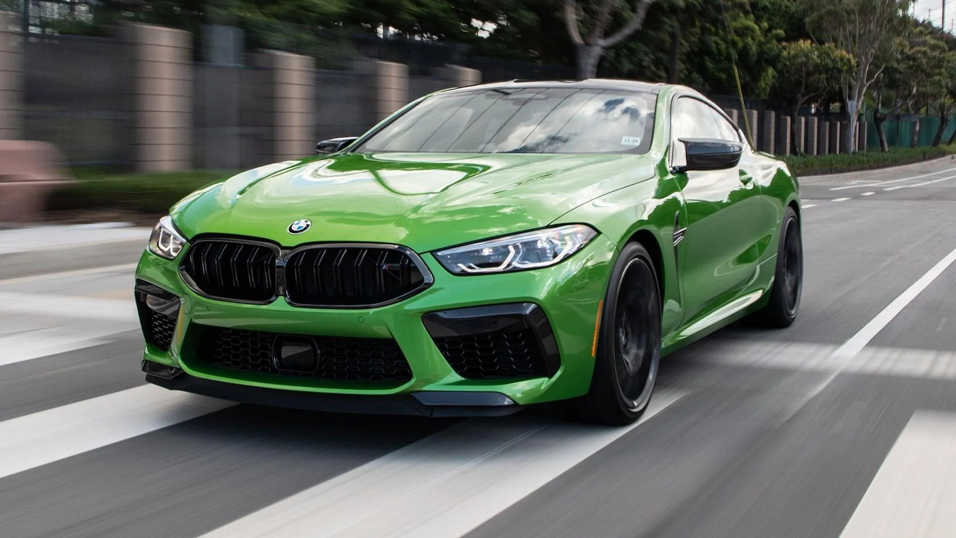 Dynamic Shot of a Green Bmw M Series Car on the Street