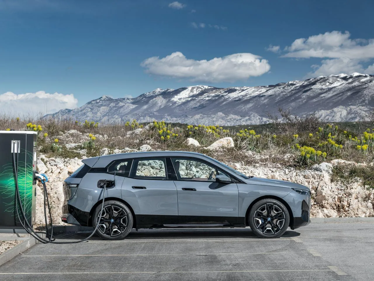 Electric Bmw Charging with Snowy Mountains Behind