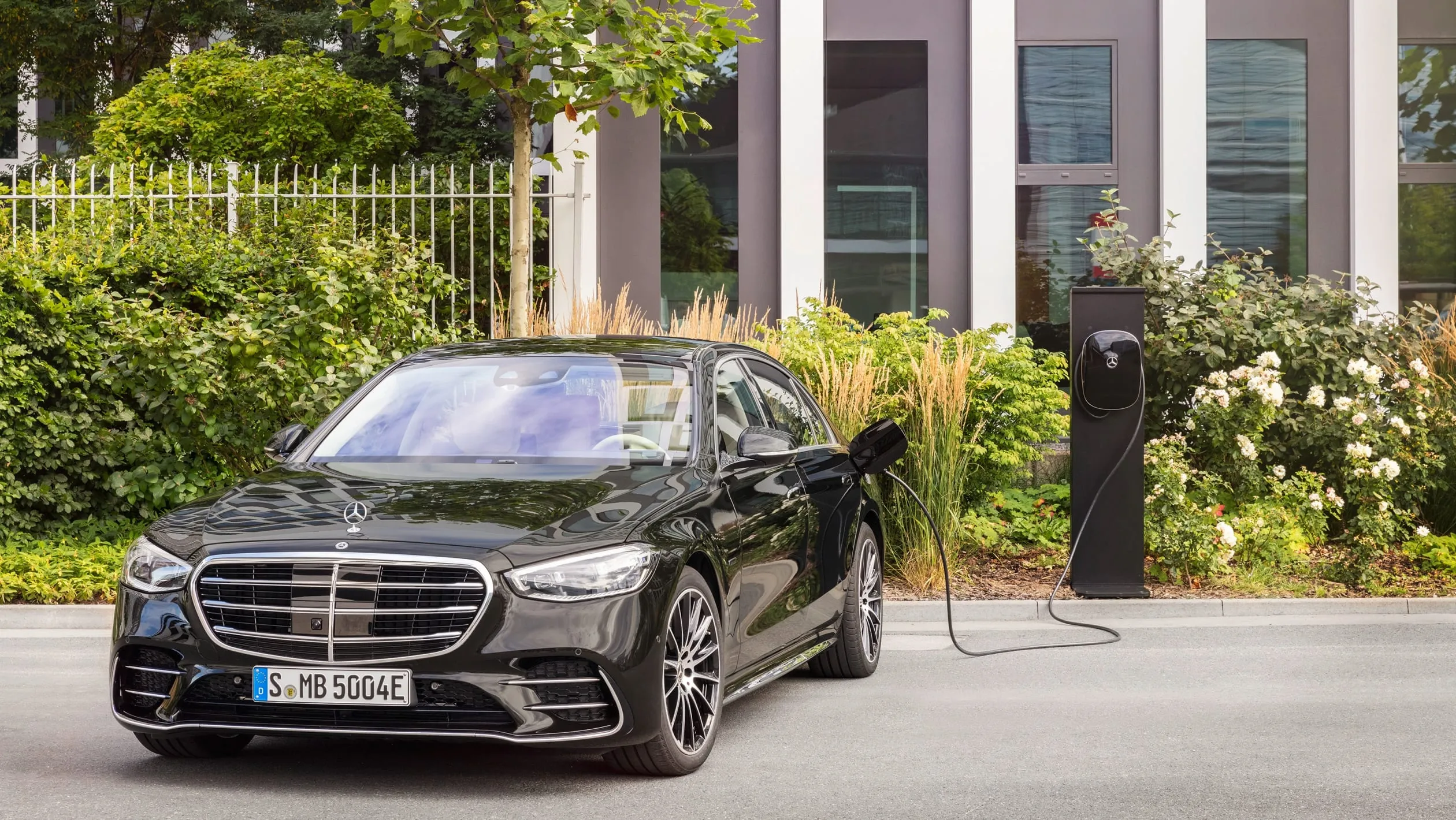 Electric Mercedes Sedan Charging at Station Wallpaper