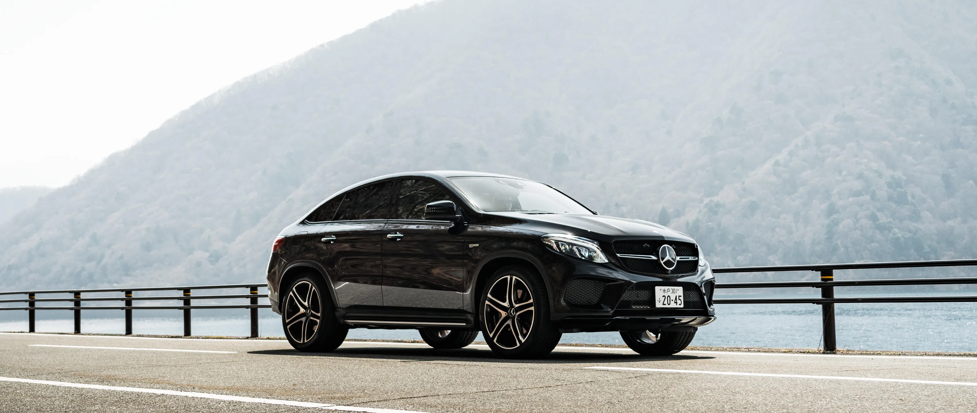 Elegant Black Mercedes Benz SUV Parked near Lake Wallpaper