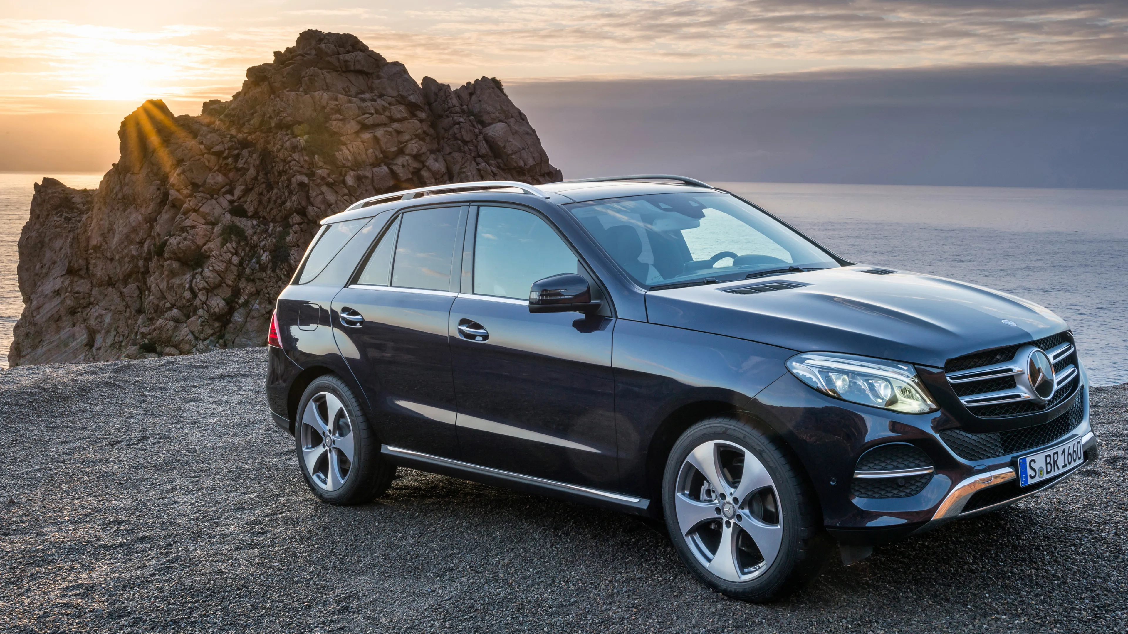 Elegant Mercedes Benz SUV Positioned Near Rocky Coast