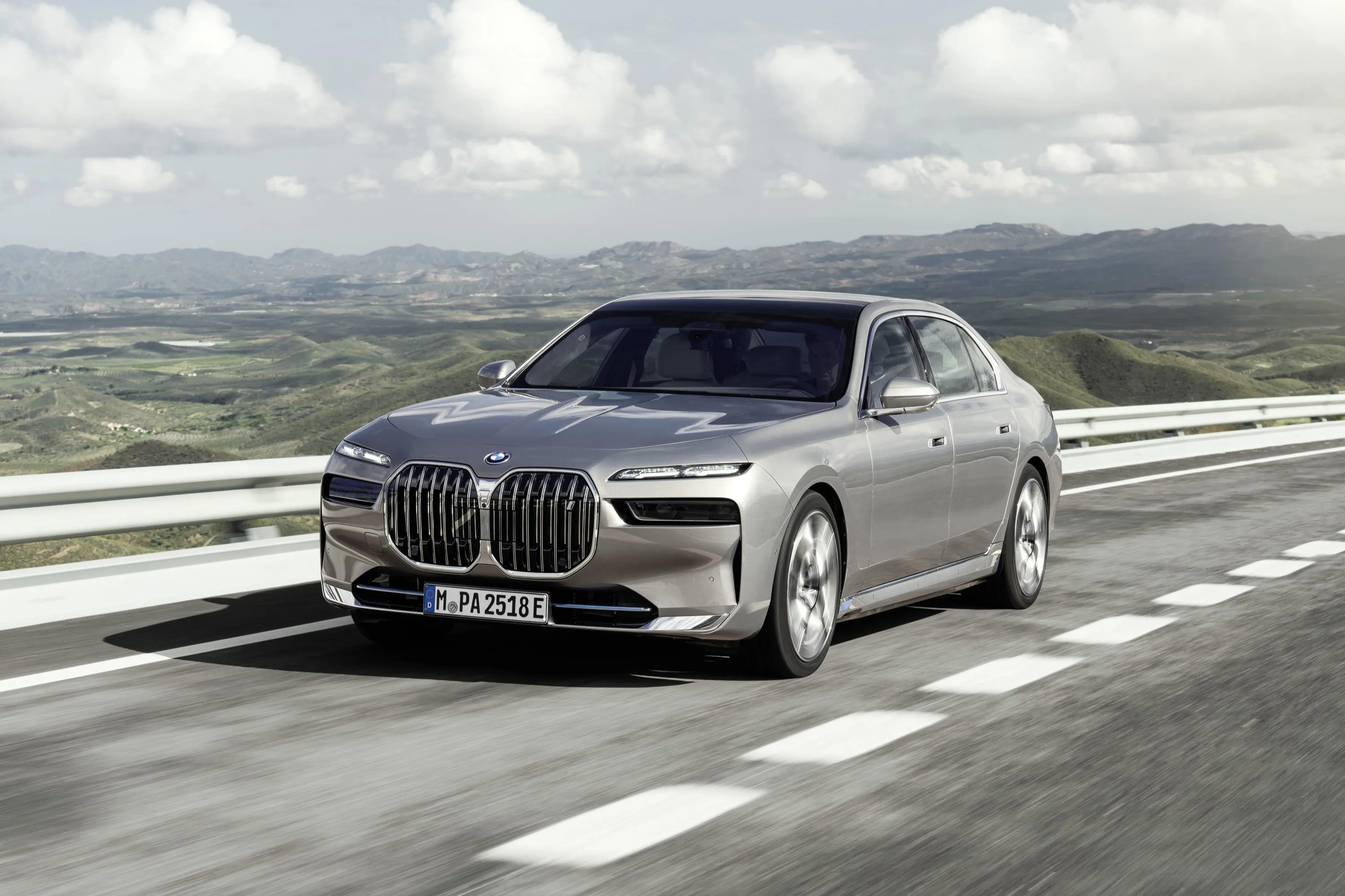 Elegant Silver Bmw Driving on a Countryside Road Wallpaper