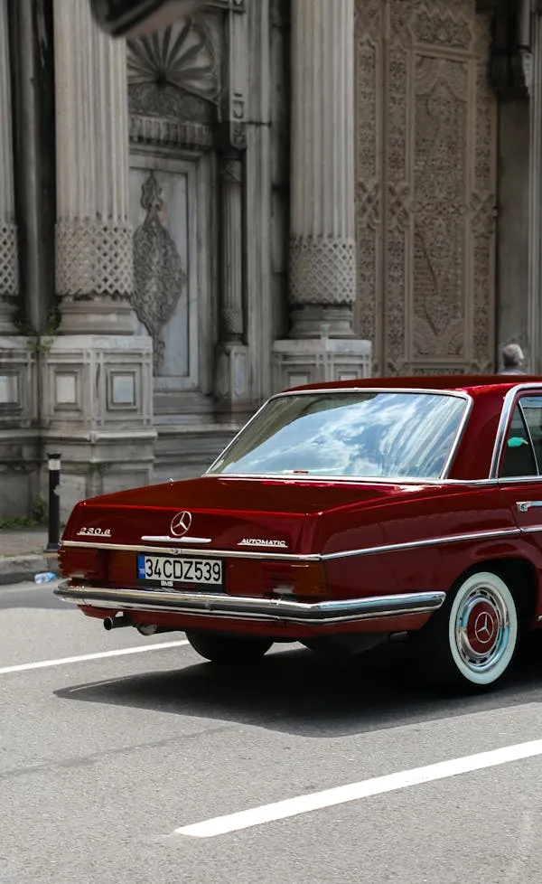 Elegant vintage Mercedes sedan in front of historic building