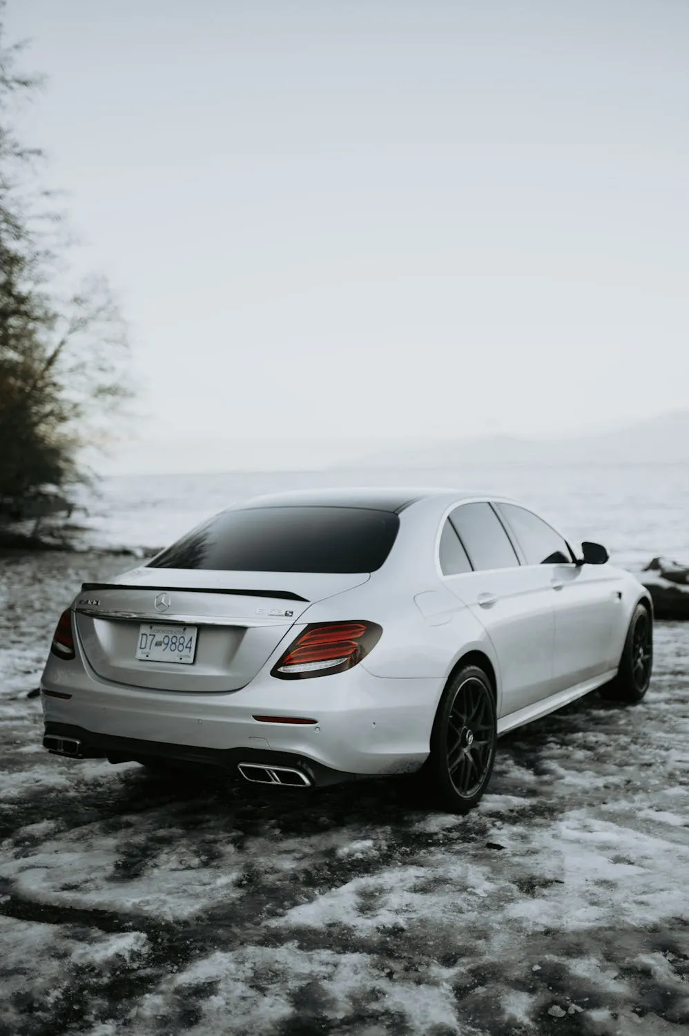 Elegant White Mercedes Benz Driving Through Winter Snow