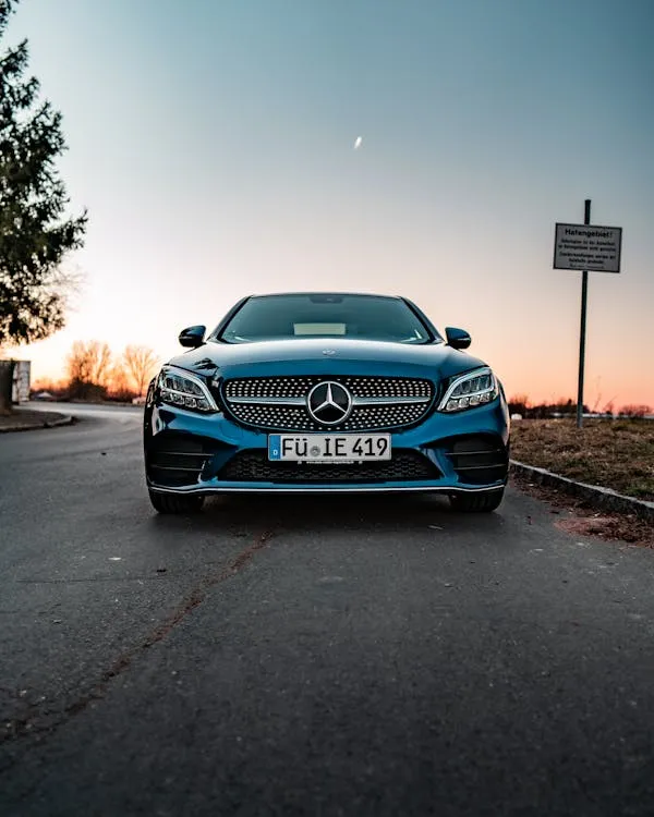 Front Angle of Mercedes Benz at Sunset Street Wallpaper