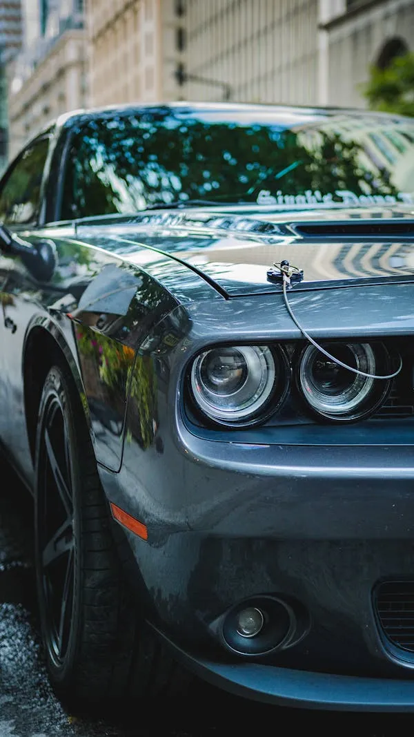 Front of Black Muscle Car Next to Benz in Street Wallpaper