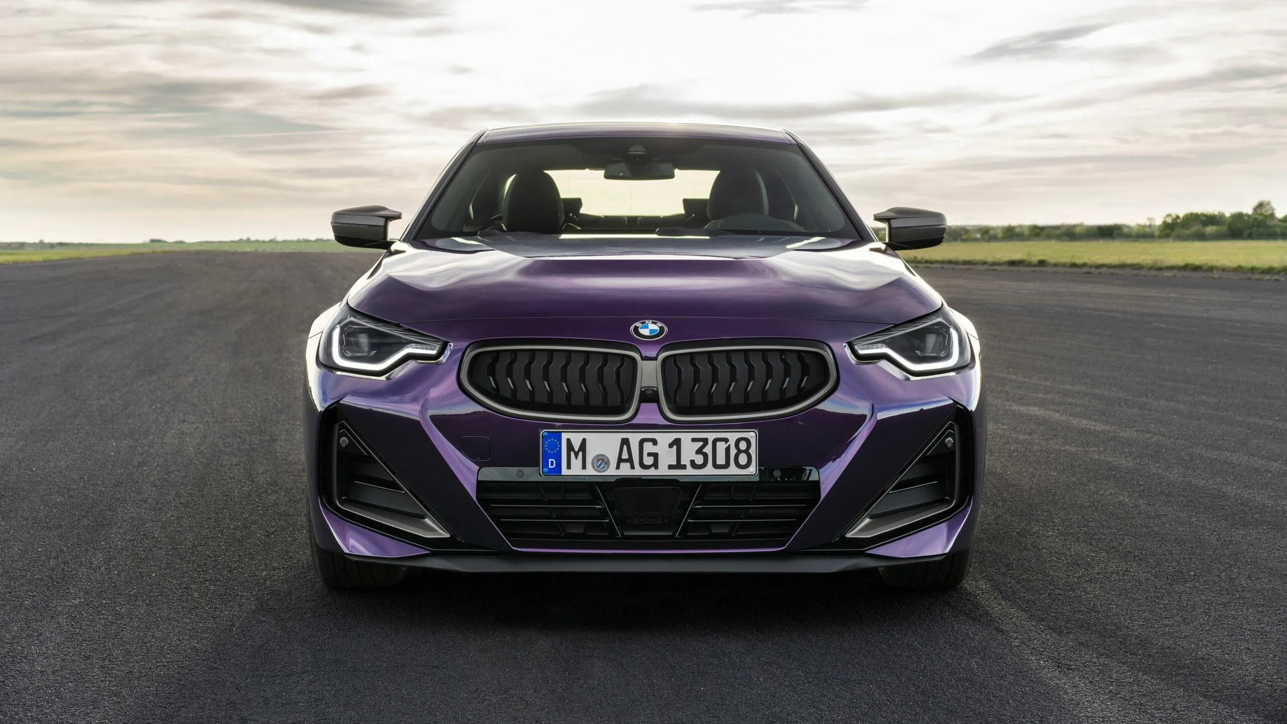 Front View of a Purple Bmw Parked on Empty Highway