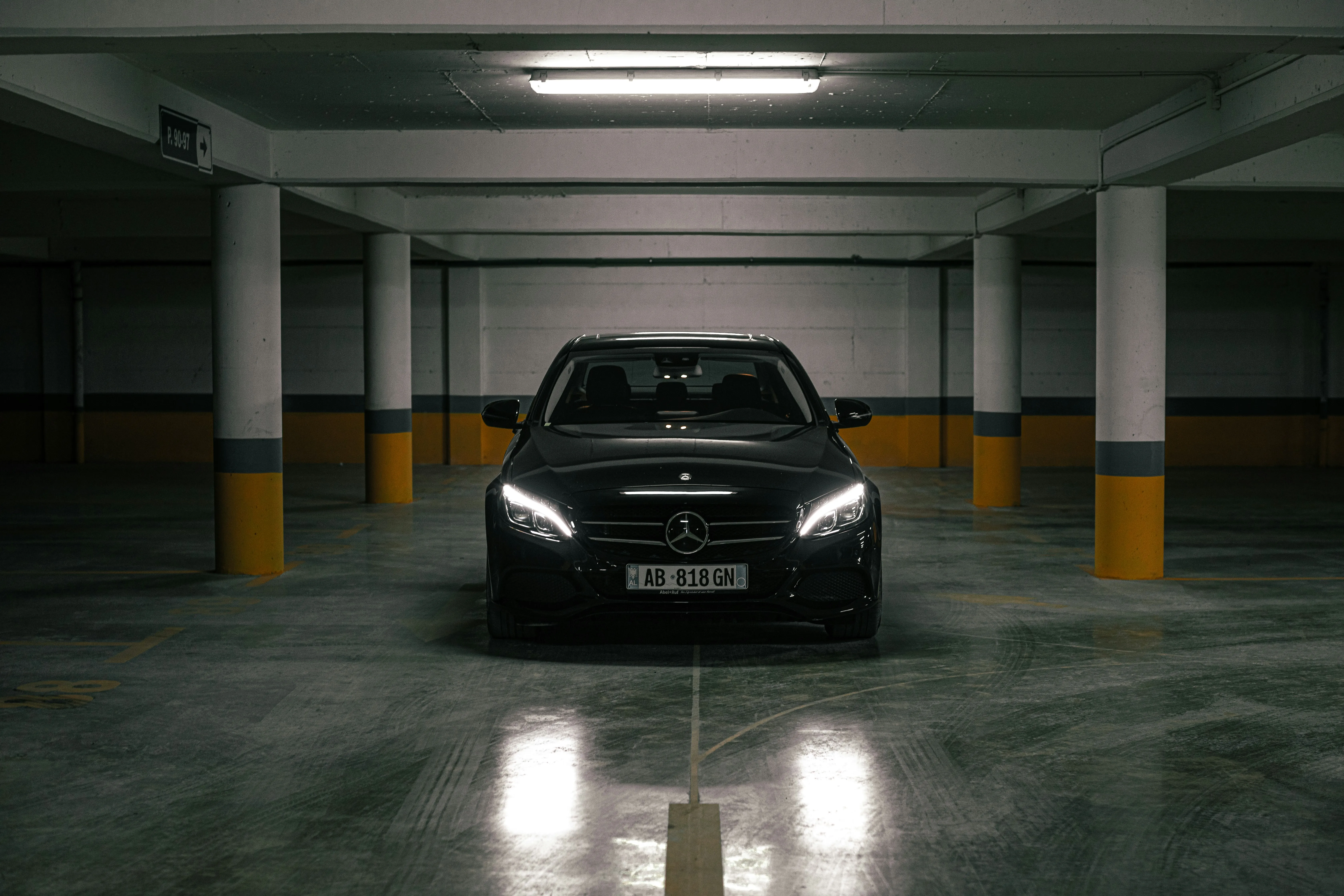 Front View of Black Benz in Indoor Parking Area Wallpaper