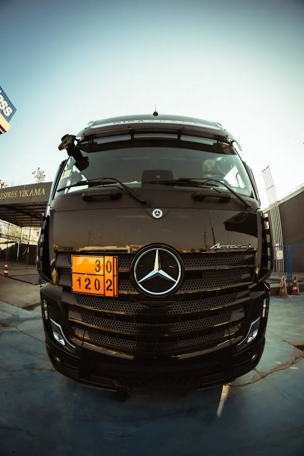 Front view of black Mercedes car with orange license plate