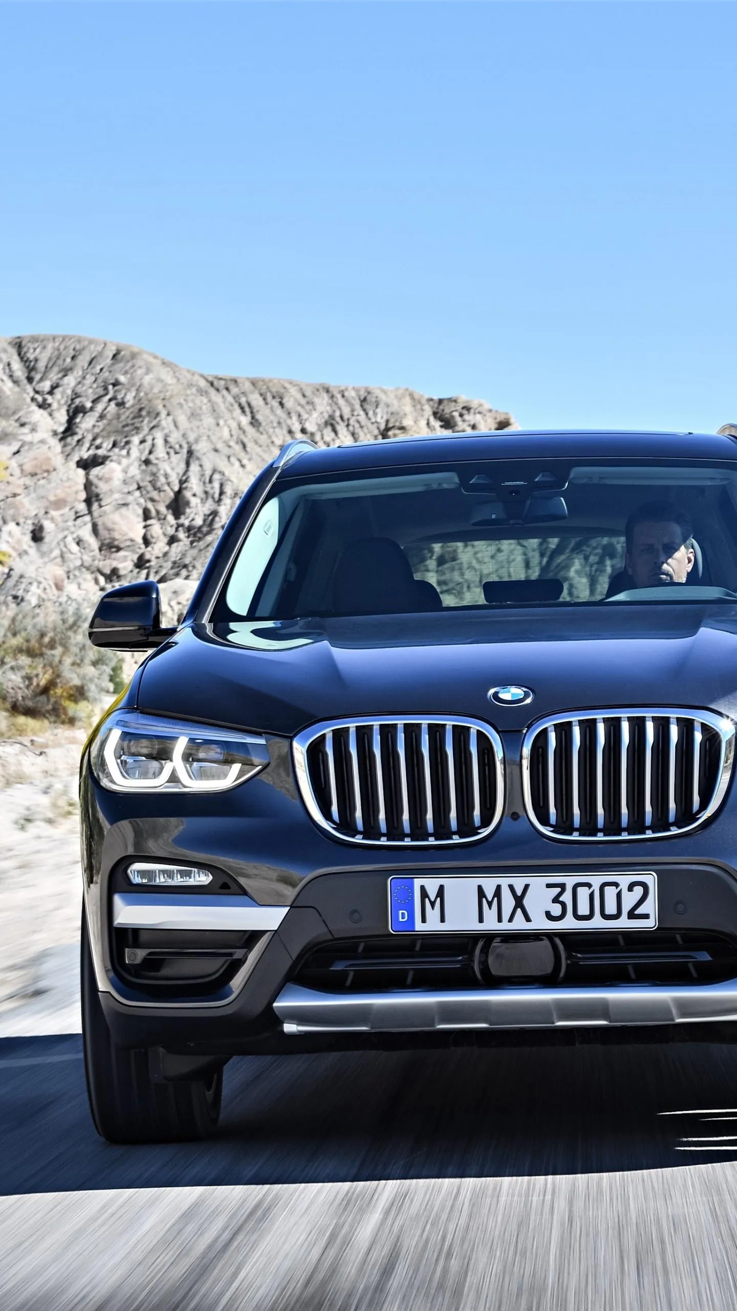 Front View of Bmw Suv Driving on City Street Fast Image