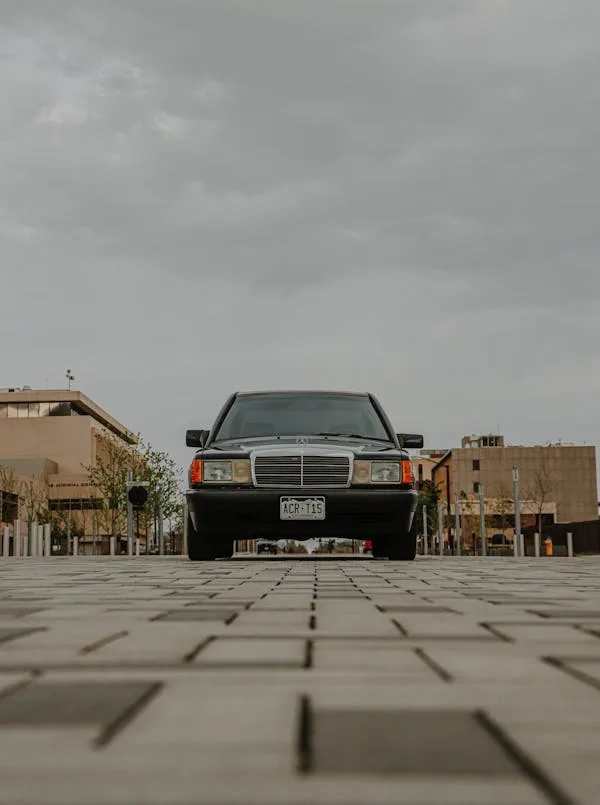 Front View of Vintage Mercedes Benz on Brick Road Wallpaper