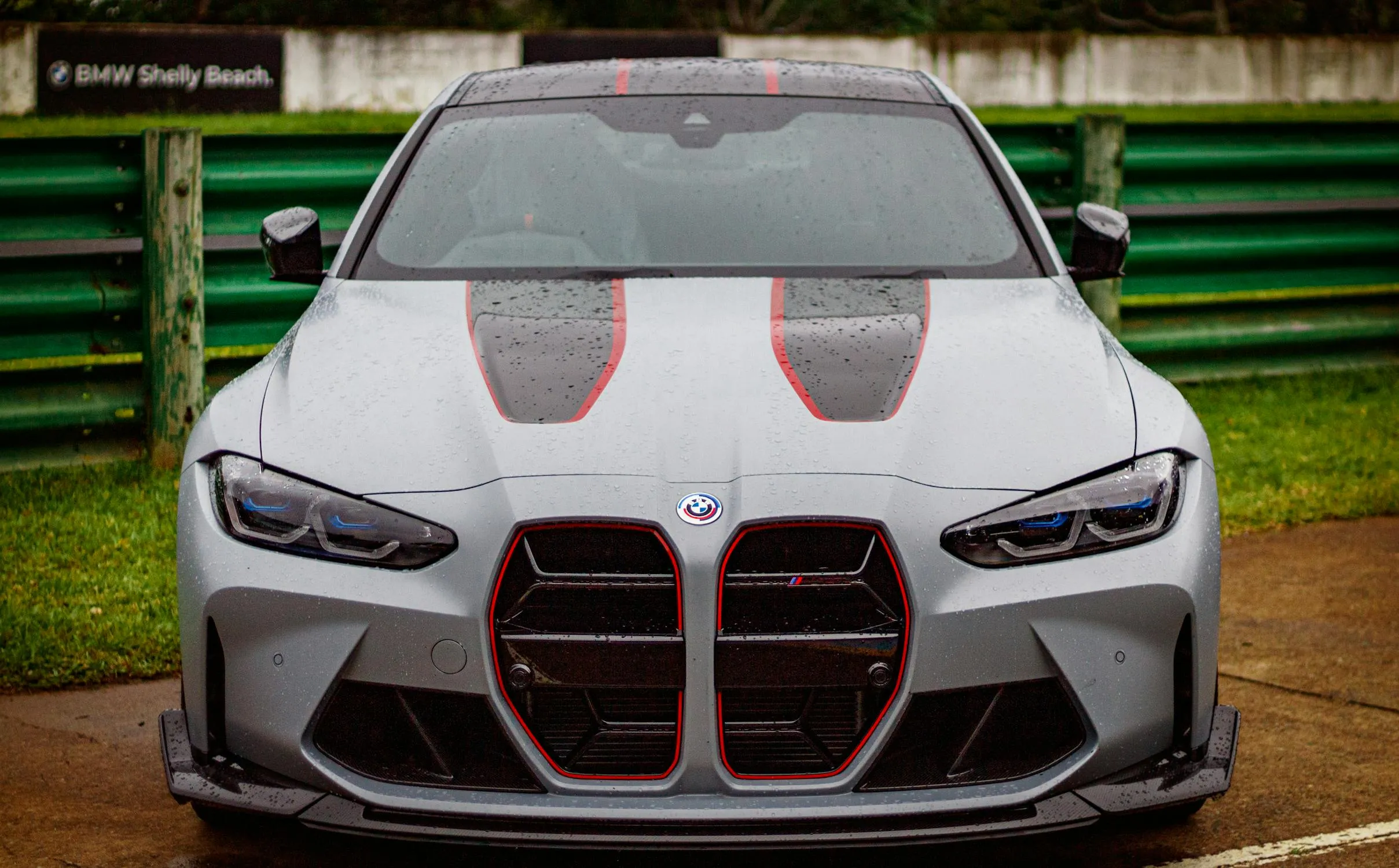 Front View of White Bmw with Racing Design on Track