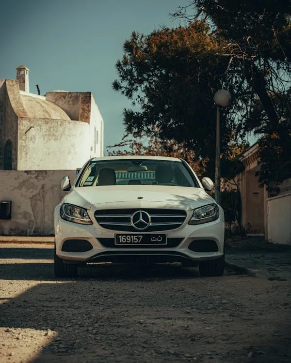 Front View of White Mercedes Benz Car Parked Outdoors