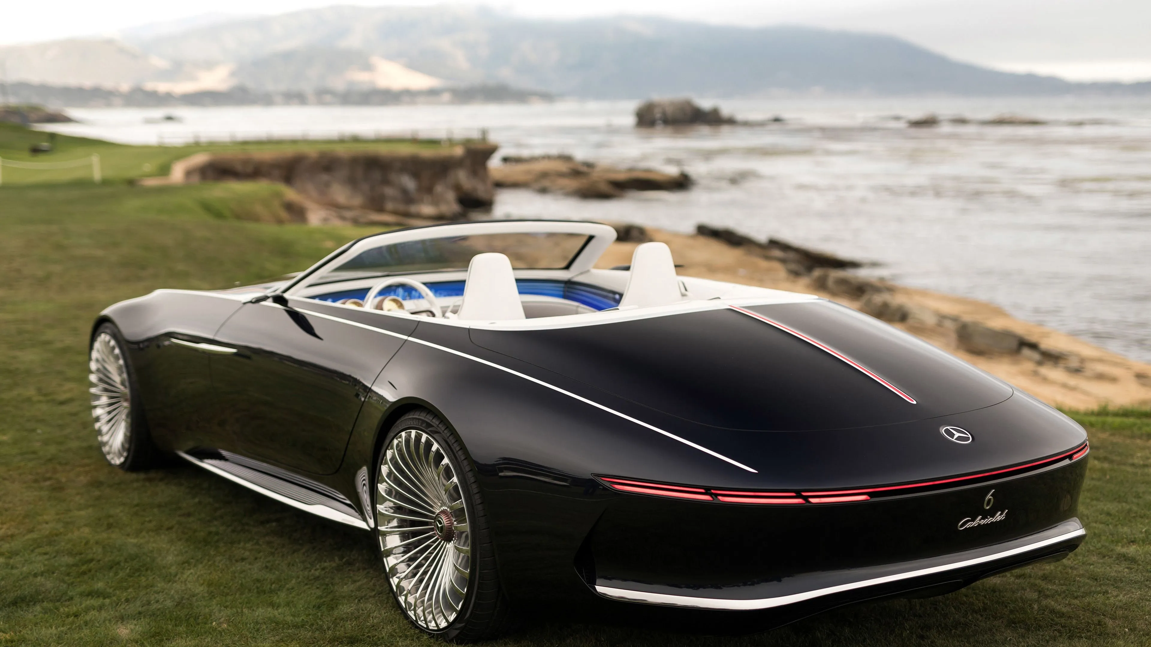 Futuristic Black Mercedes Convertible parked near Ocean