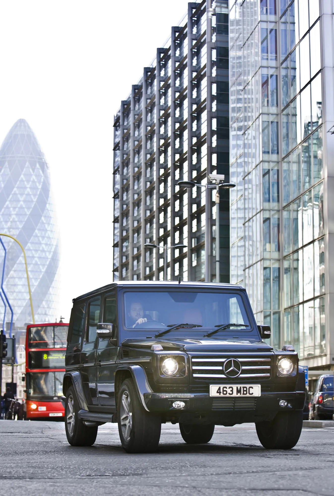 G Wagon on City Streets Surrounded by Modern Buildings