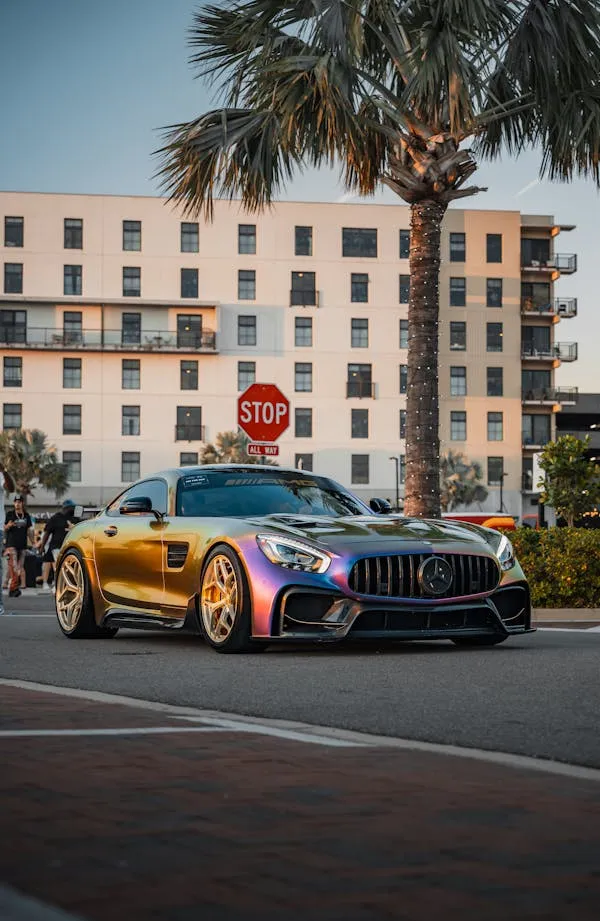 Gold Mercedes AMG Sports Car in Palm City Road Wallpaper
