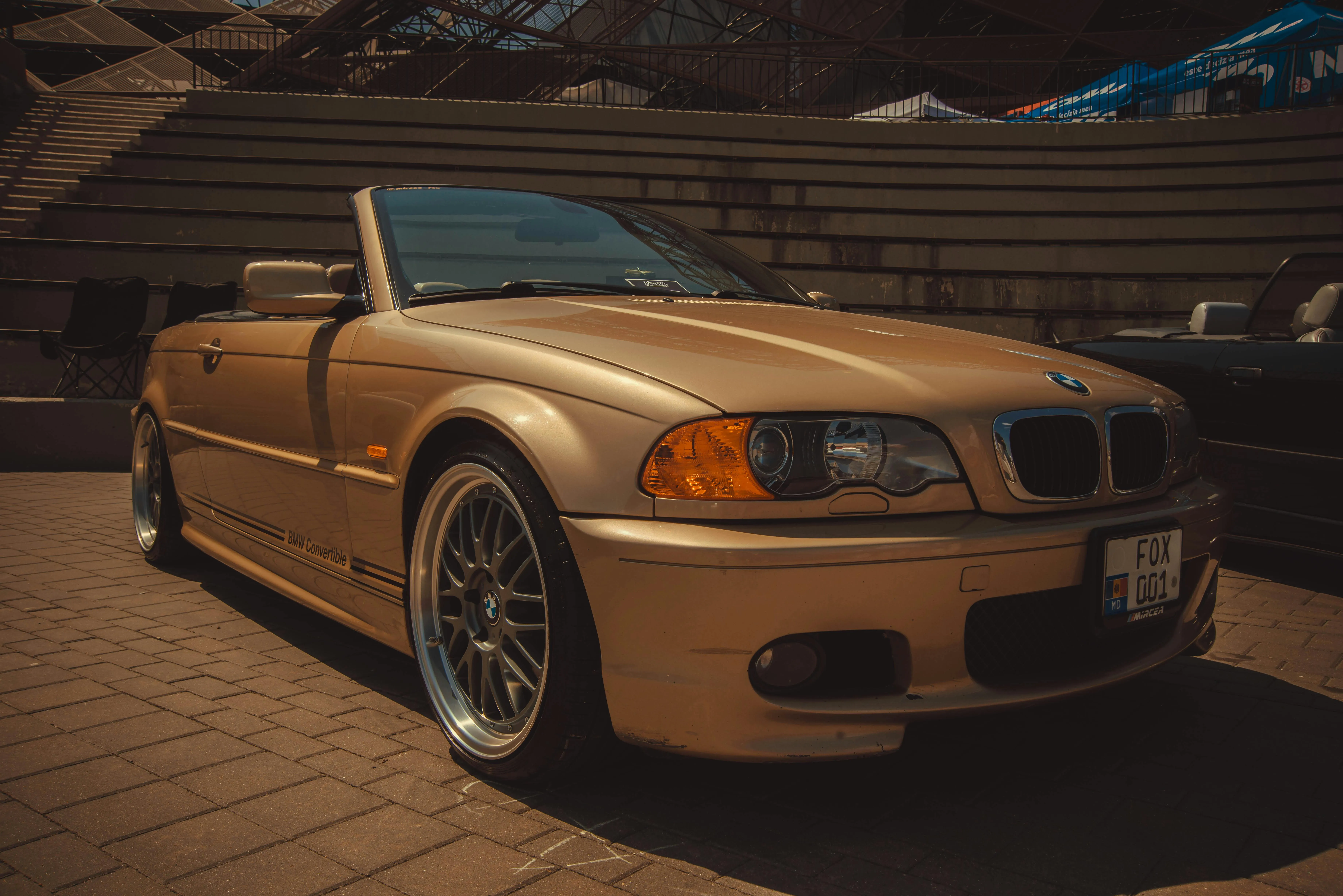 Golden Bmw Convertible Parked Indoors with Dim Lighting