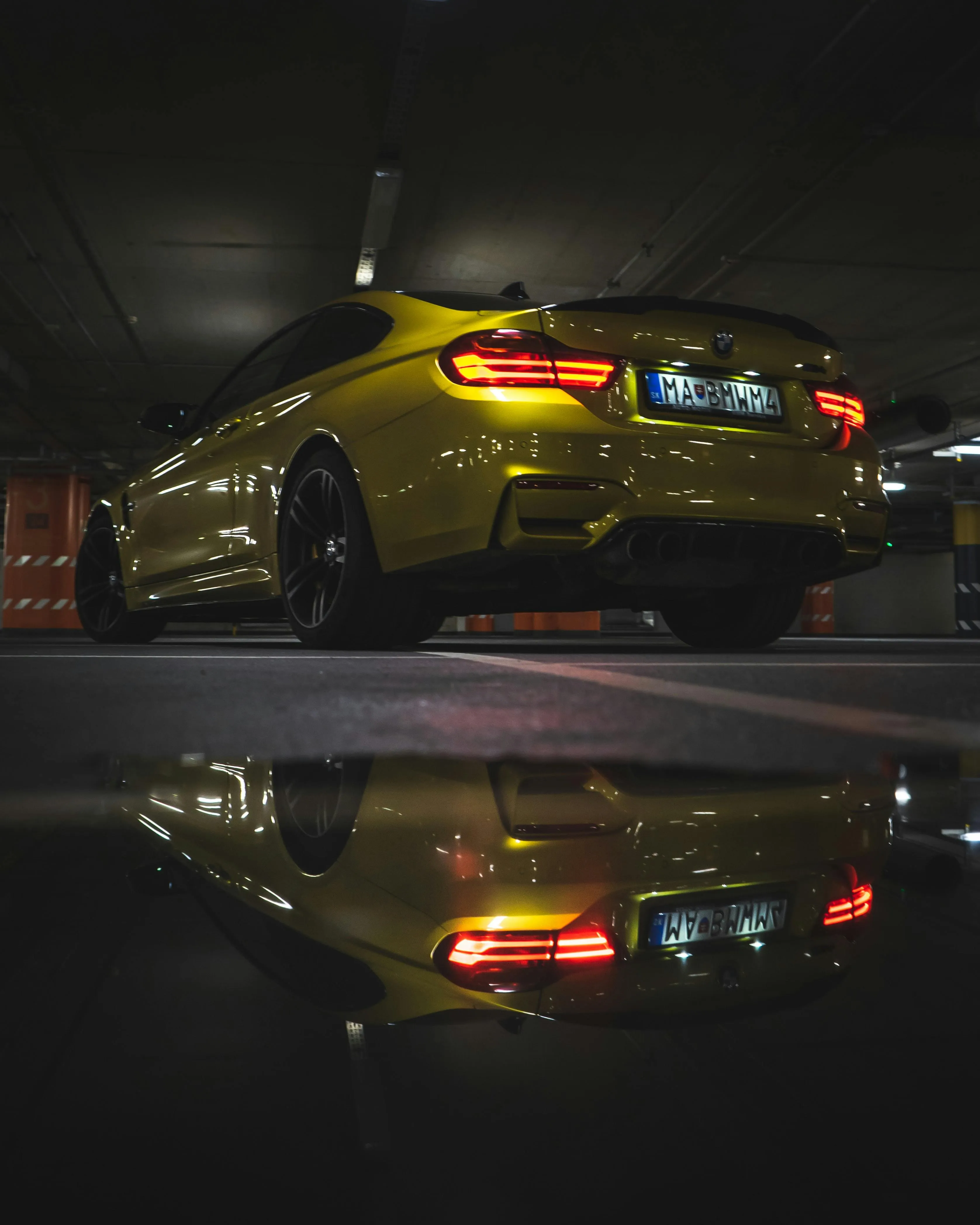 Golden Bmw Under Garage Light with Moody Reflection