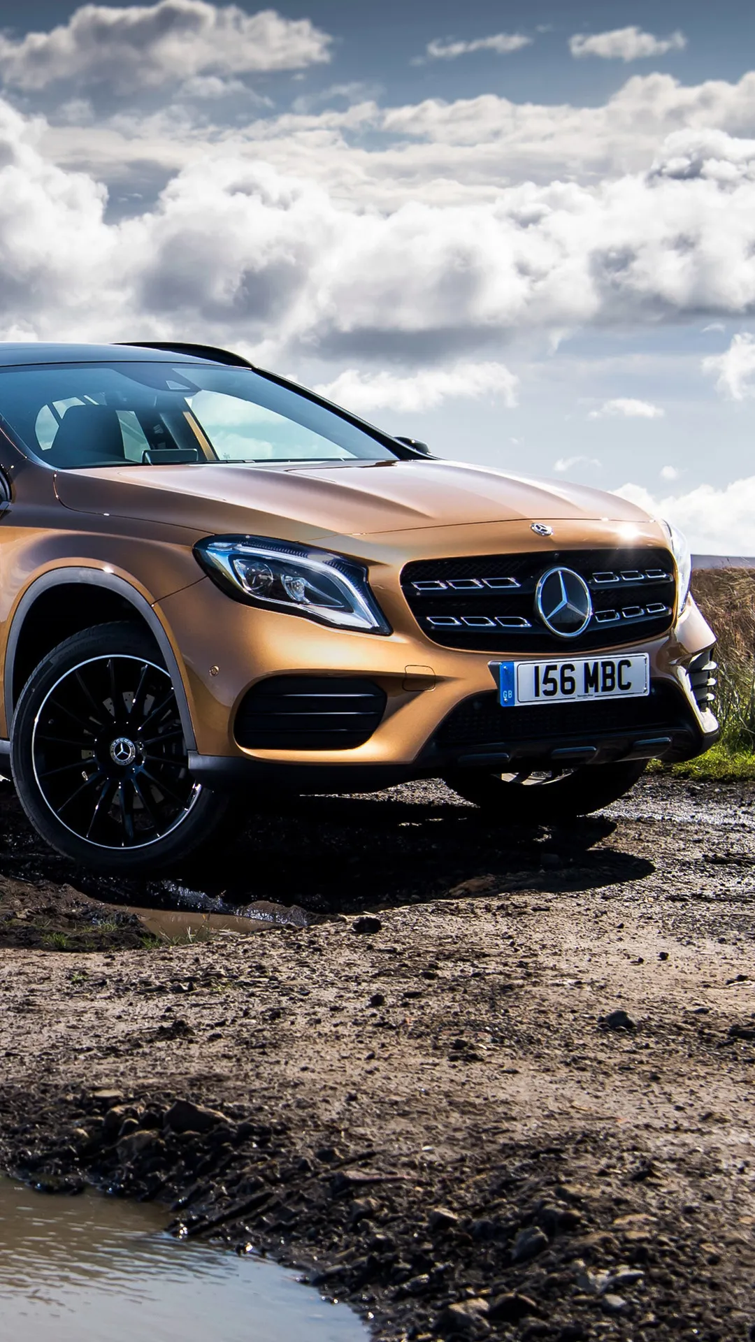 Golden Mercedes Benz SUV Parked on Dirt Road in Sunny Weather
