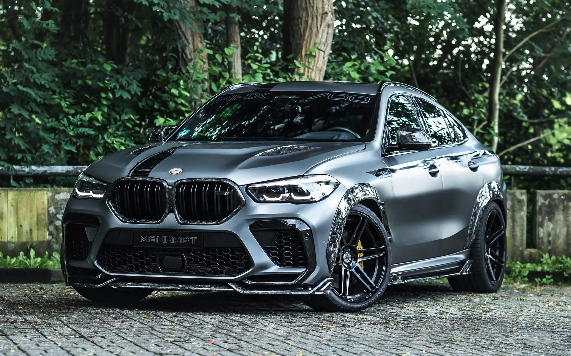 Gray Bmw Sports Car Surrounded By Trees and Natural Scenery