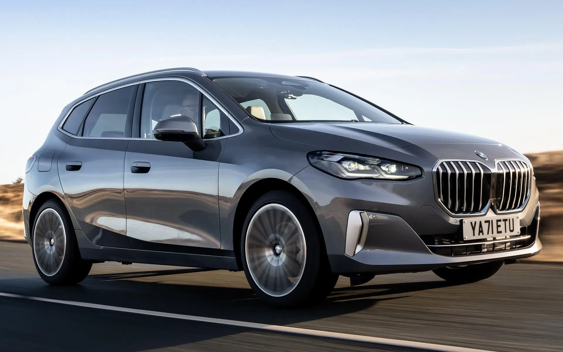Gray Bmw Suv Driving on Clear Road Under Blue Sky Image