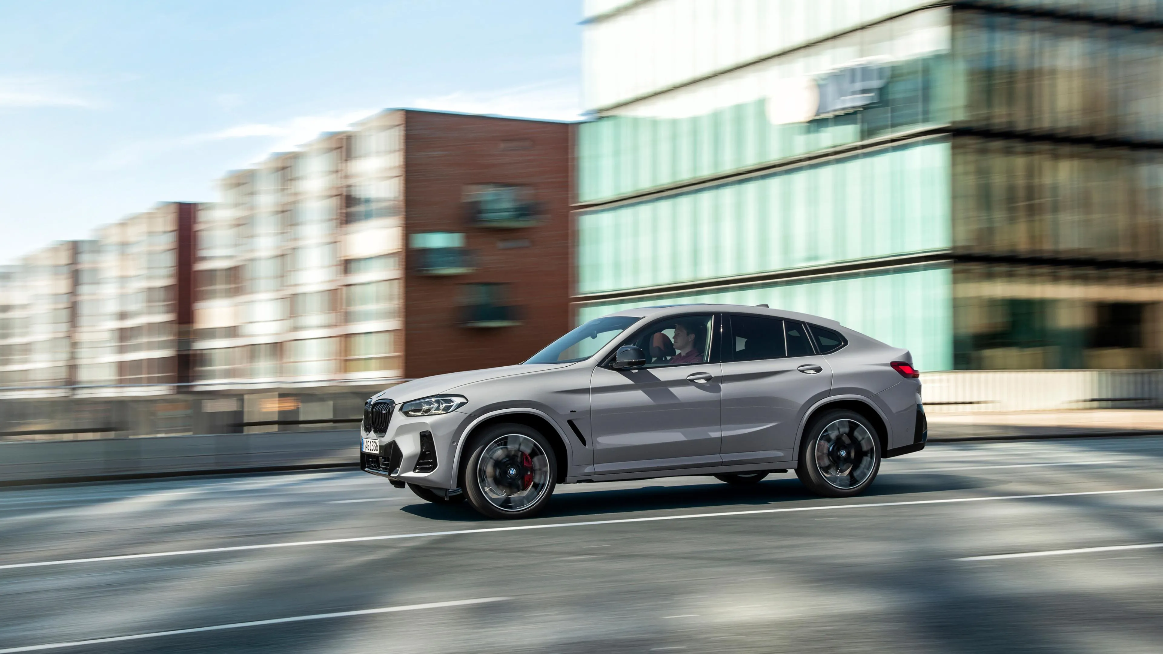 Gray Bmw Suv Near Modern Buildings in Urban Environment