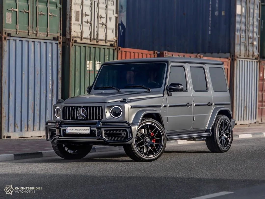 Gray Mercedes G Wagon Parked by Shipping Containers