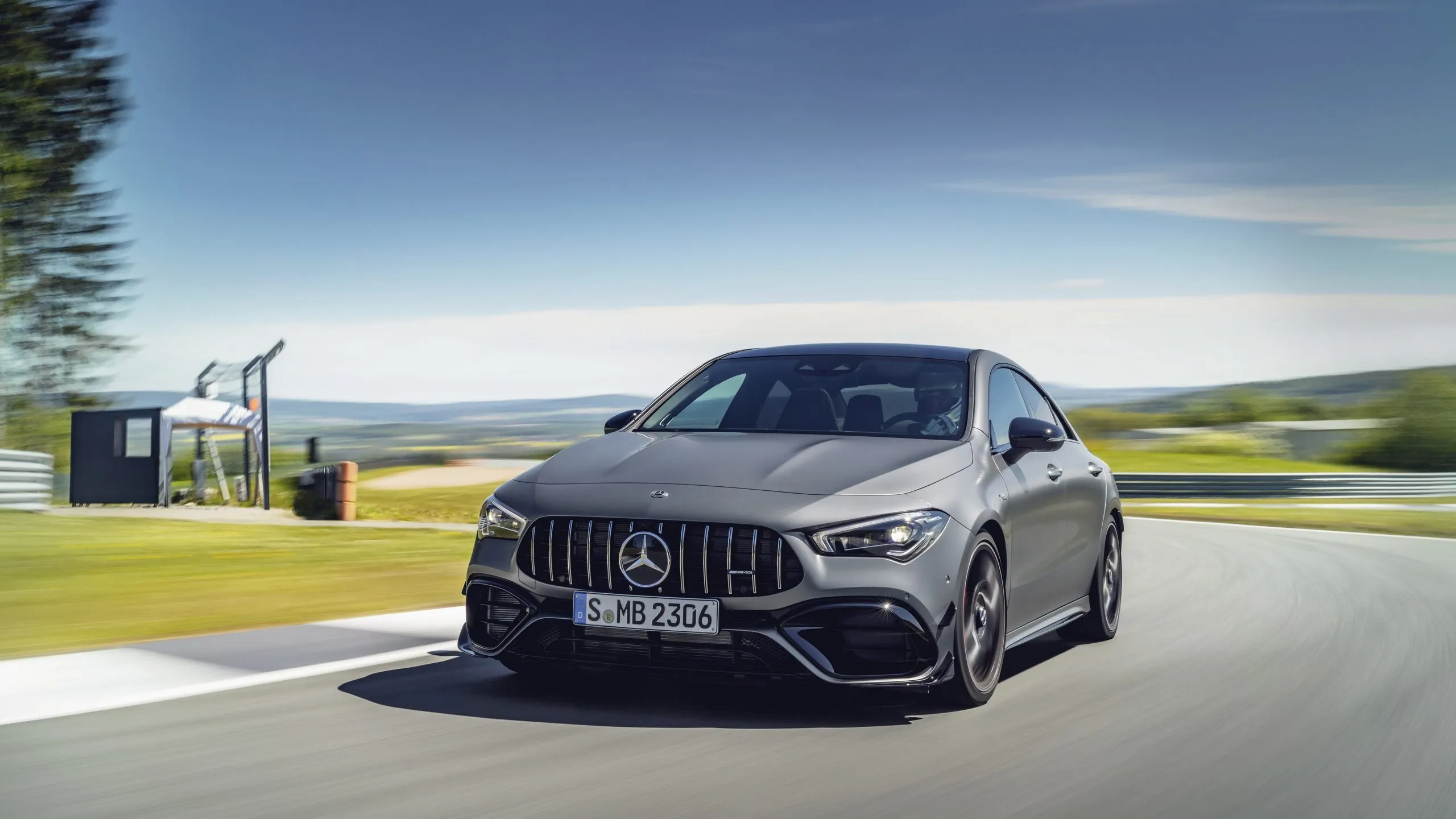 Gray Mercedes Sedan Driving On A Country Road Wallpaper
