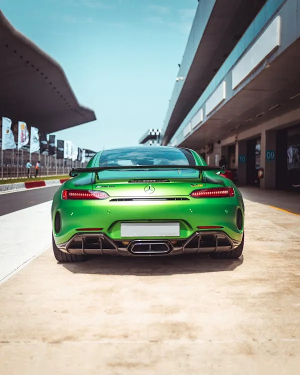 Green AMG Mercedes Benz Parked Under Modern Roof Wallpaper