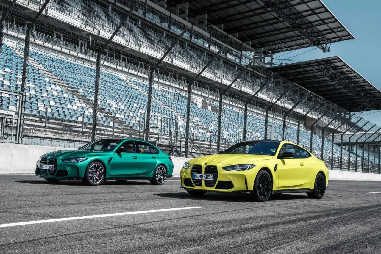 Green and Yellow Bmw Cars on Racing Track Pit Lane Image