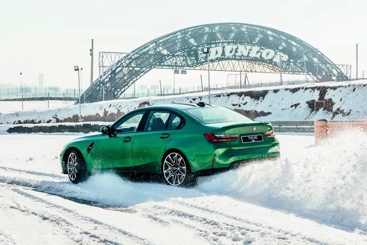 Green Bmw Car Drifting in Snow Near Dunlop Bridge Wallpaper