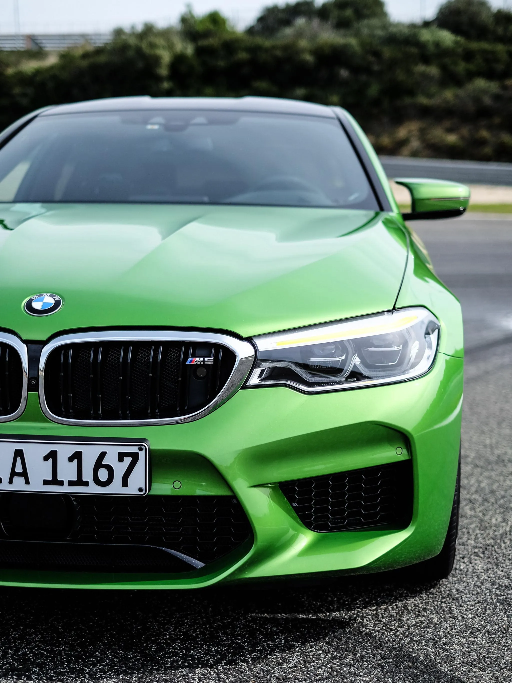 Green Bmw Front View Captured on City Street Close Up