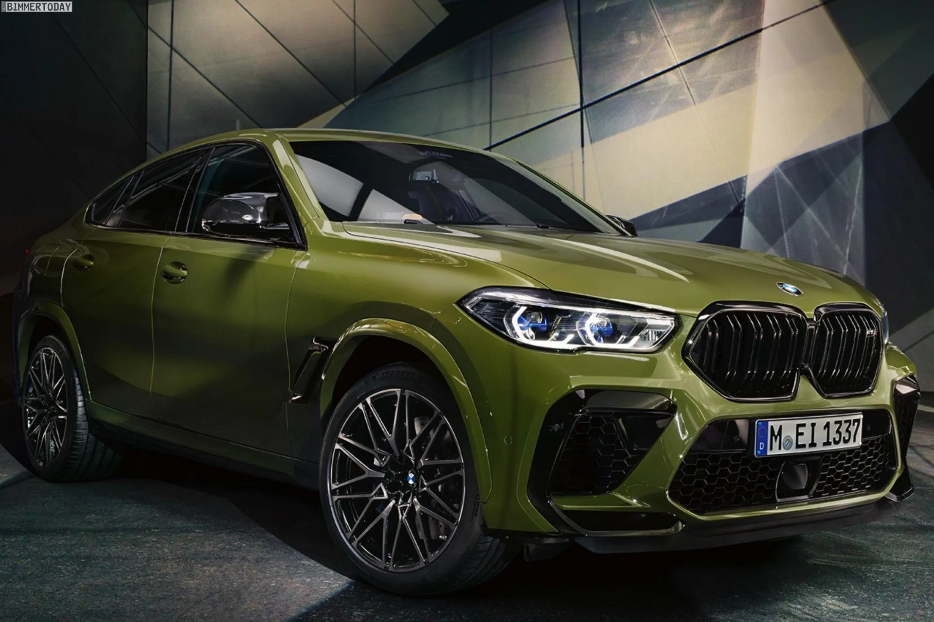 Green Bmw M Series Suv Posed in Showroom Setting Image