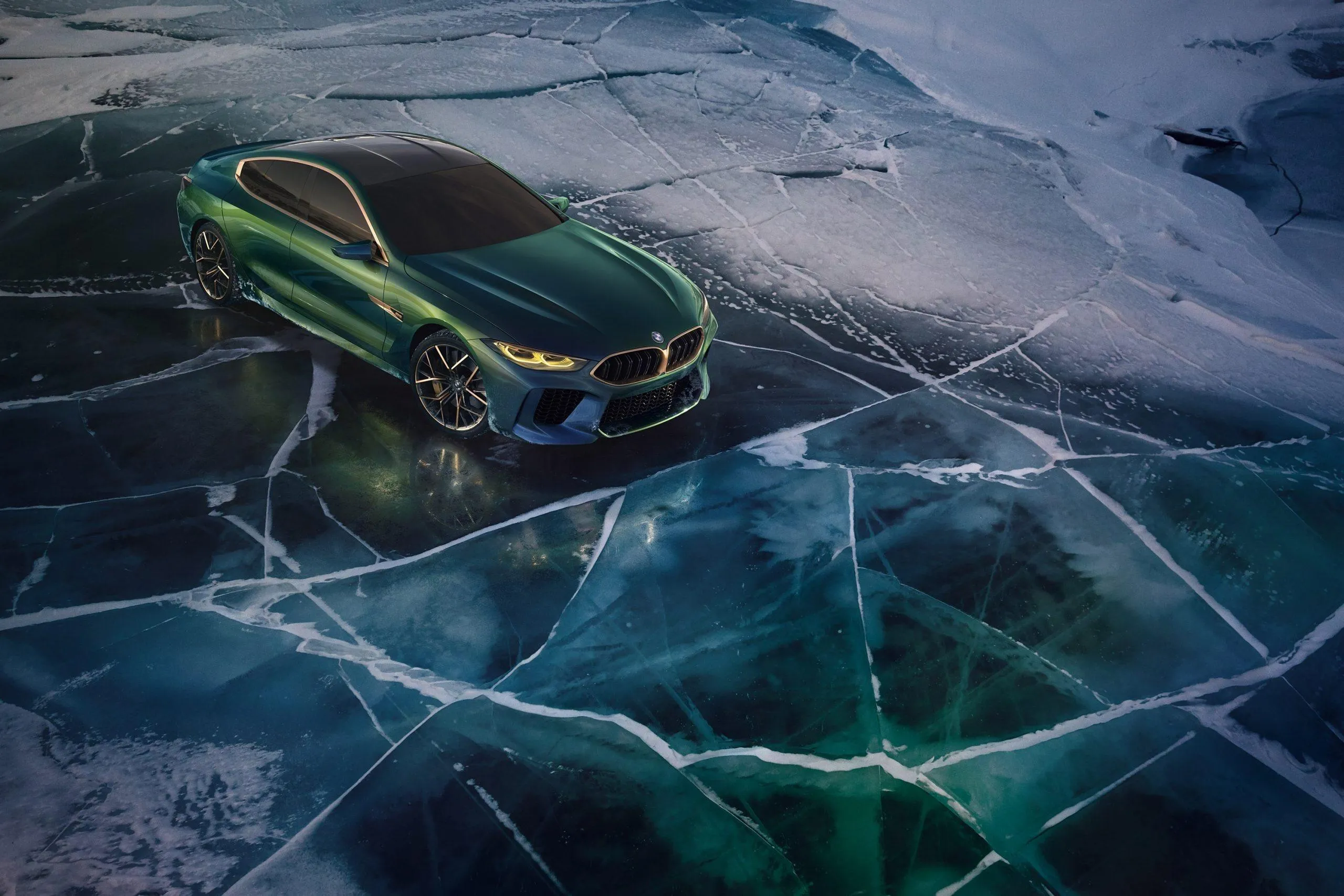 Green Bmw Parked on Icy Cracked Frozen Lake Surface
