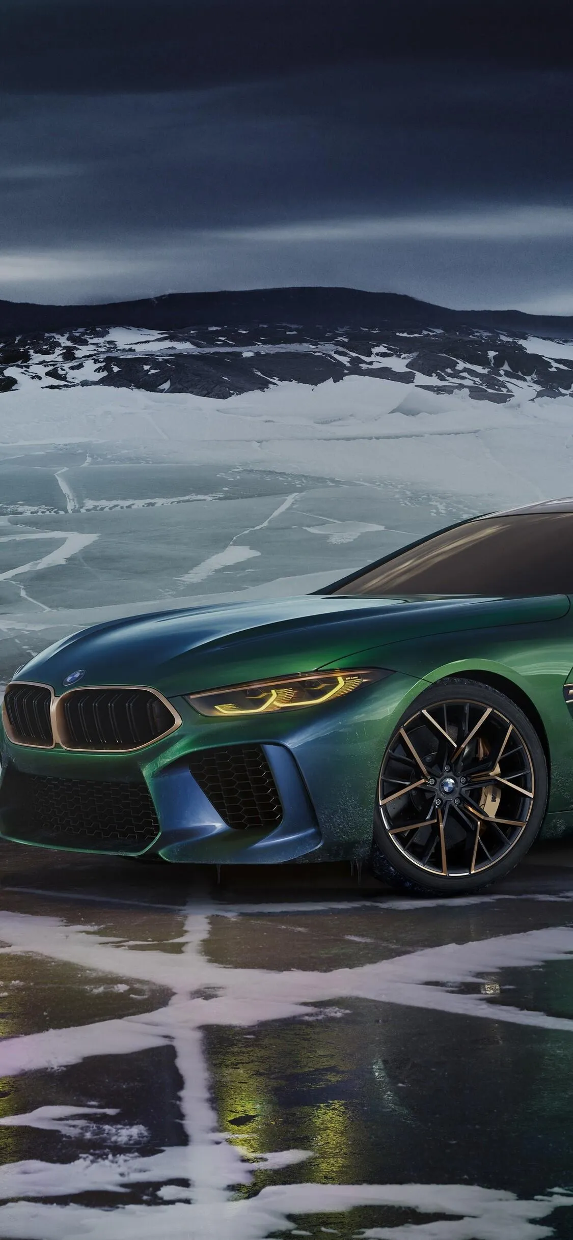 Green Bmw Sports Car Parked on a Snowy Mountain Wallpaper