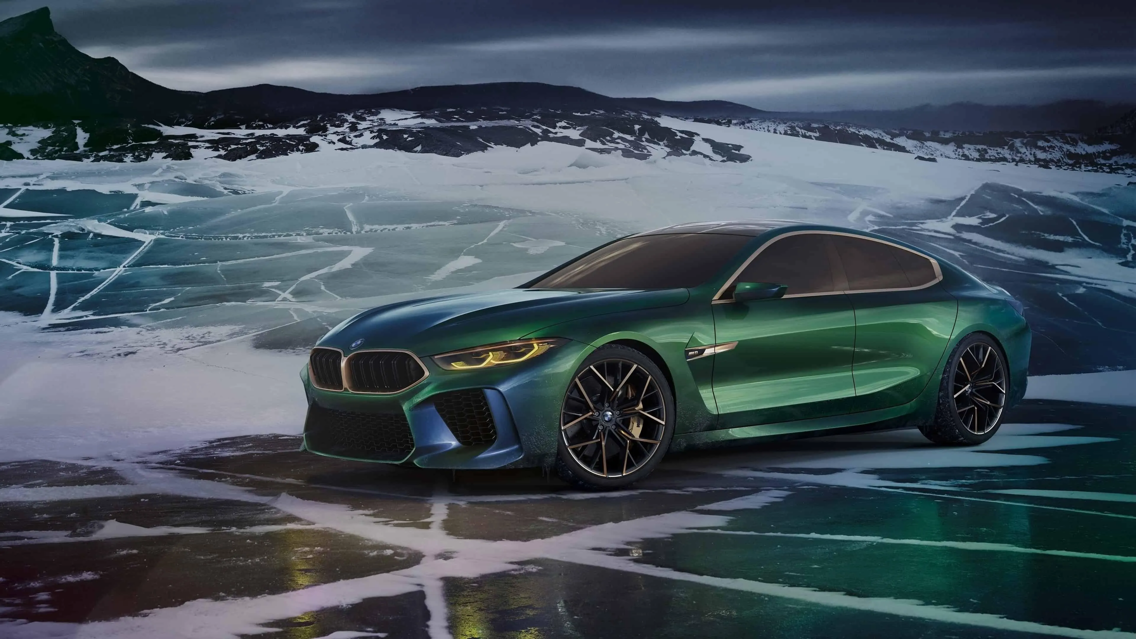 Green Bmw Sports Coupe Driving on an Icy Mountain Road