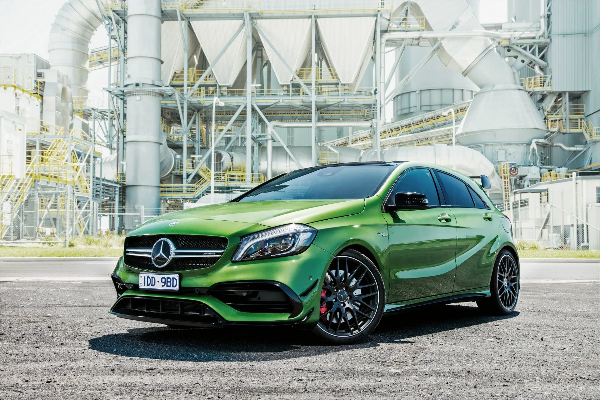 Green Mercedes Benz Hatchback in Industrial Area Wallpaper