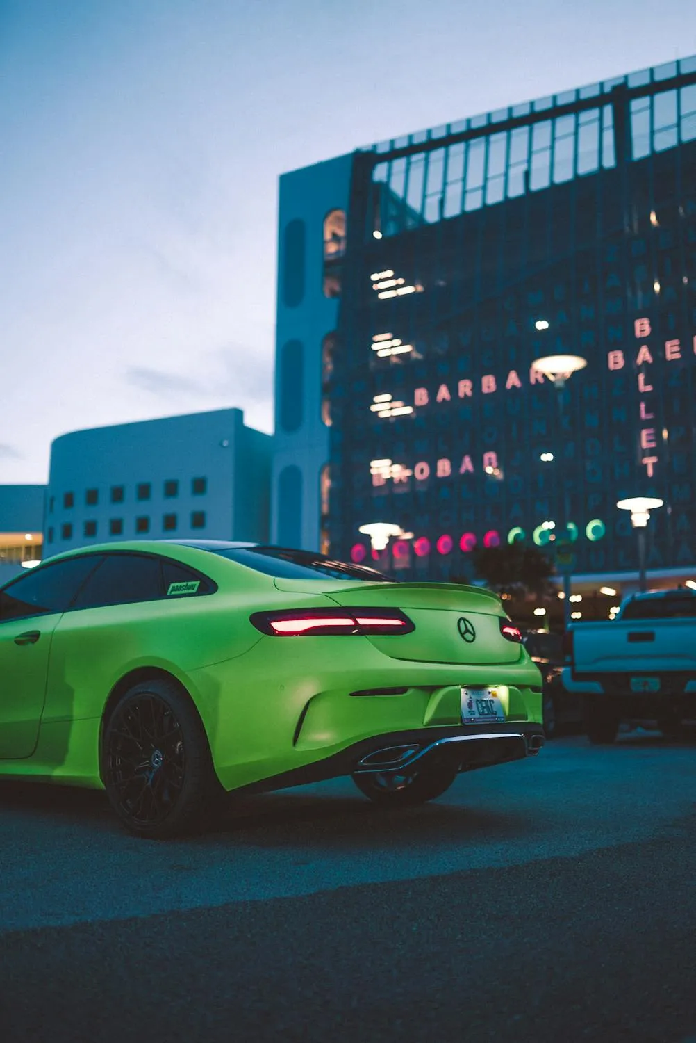 Green Mercedes Benz Parked in Front of Urban Buildings